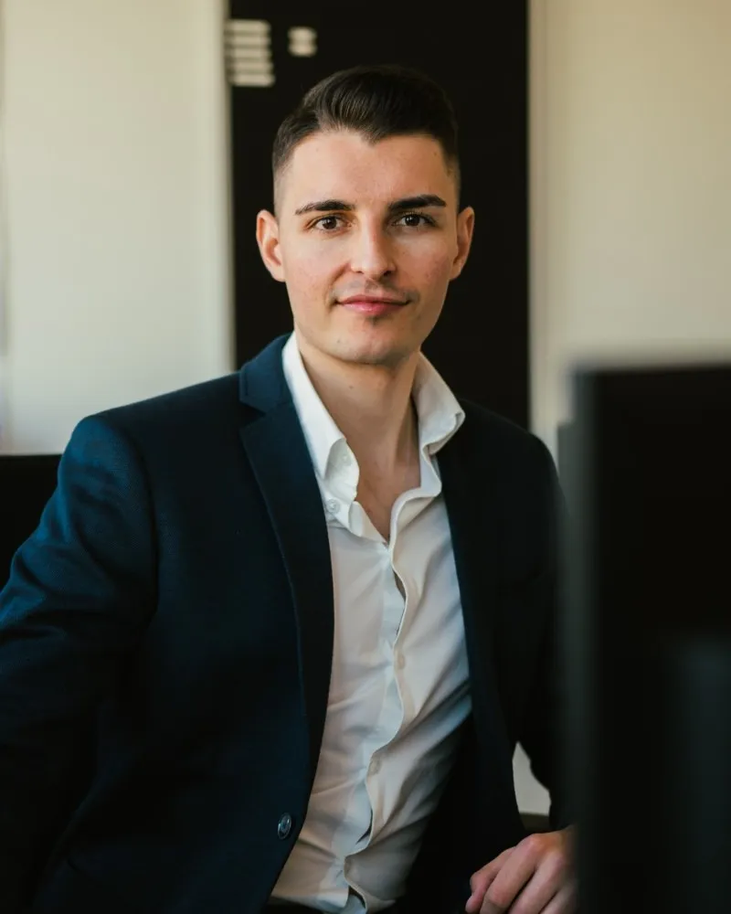 Nolen Kunert, Gründer von Kunert.Concept, sitzt im Büro und blickt in die Kamera